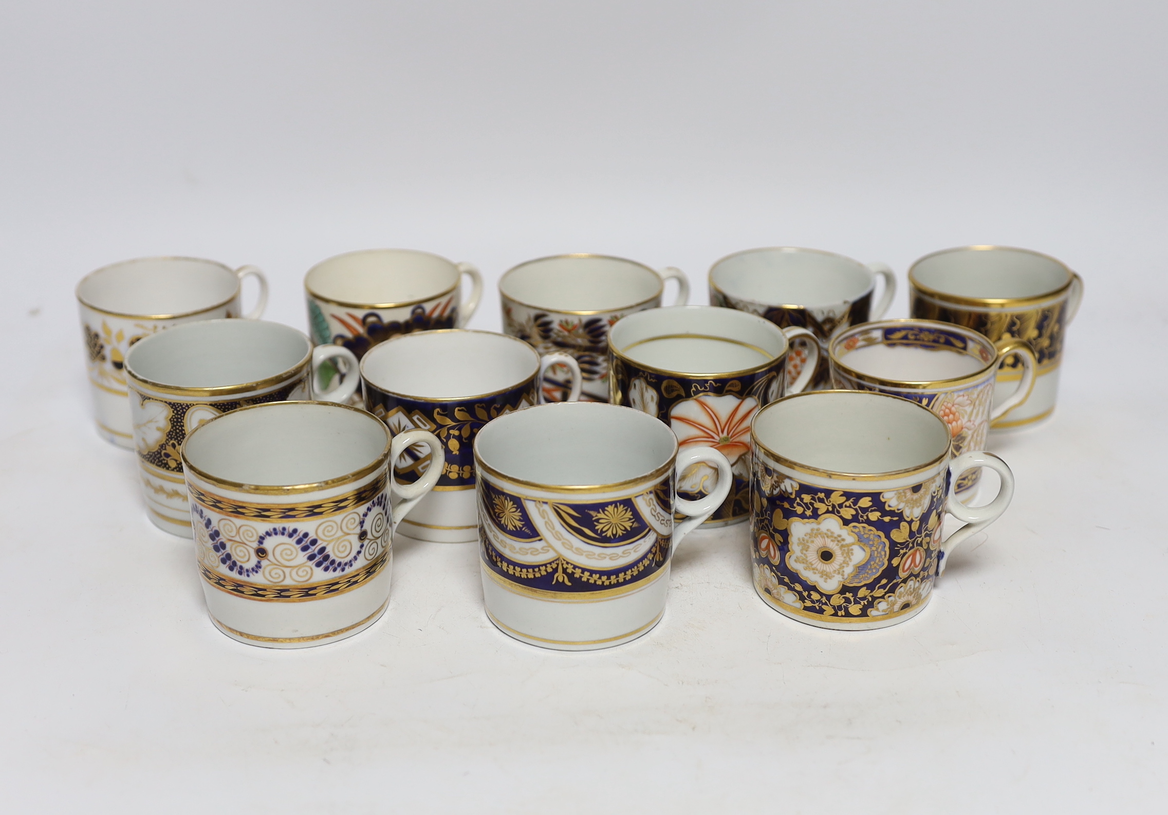 Twelve 1800-1820 English porcelain coffee cans, including Imari pattern examples